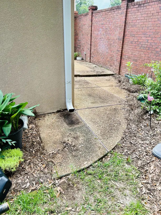 Walkway beside a brick wall