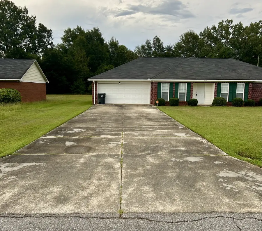 Concrete driveway at a brick home
